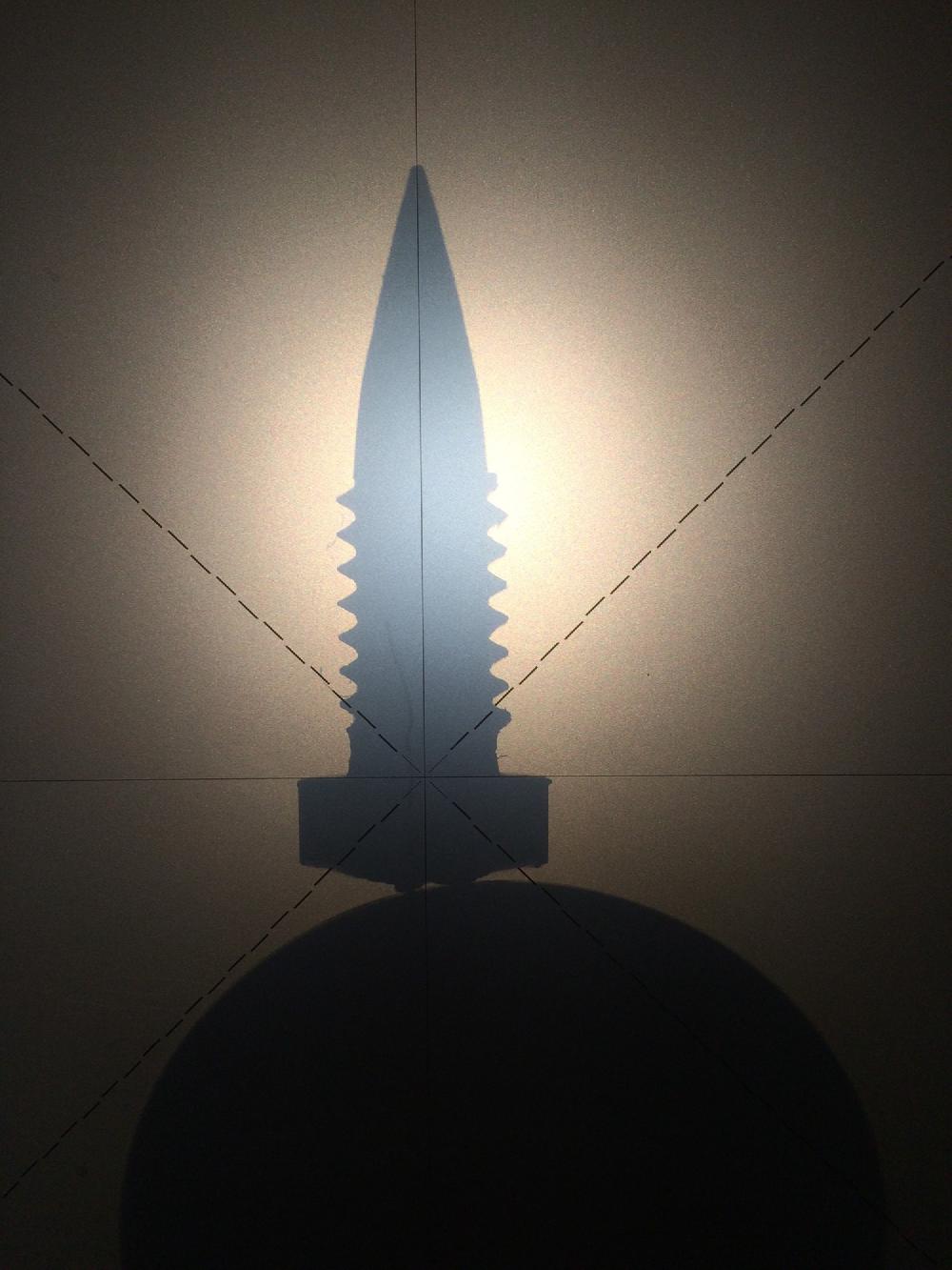 Pivot screw in an optical comparator tool.