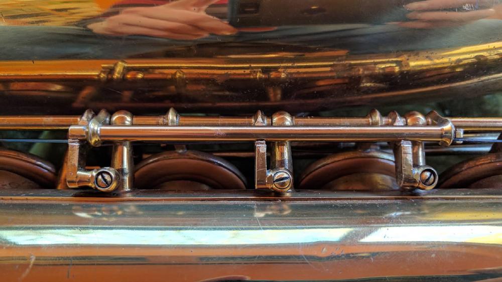 Selmer's version of the adjustable key foot. Different than the adjustable F# adjustment! I have only seen one or the other, never both on the same horn.