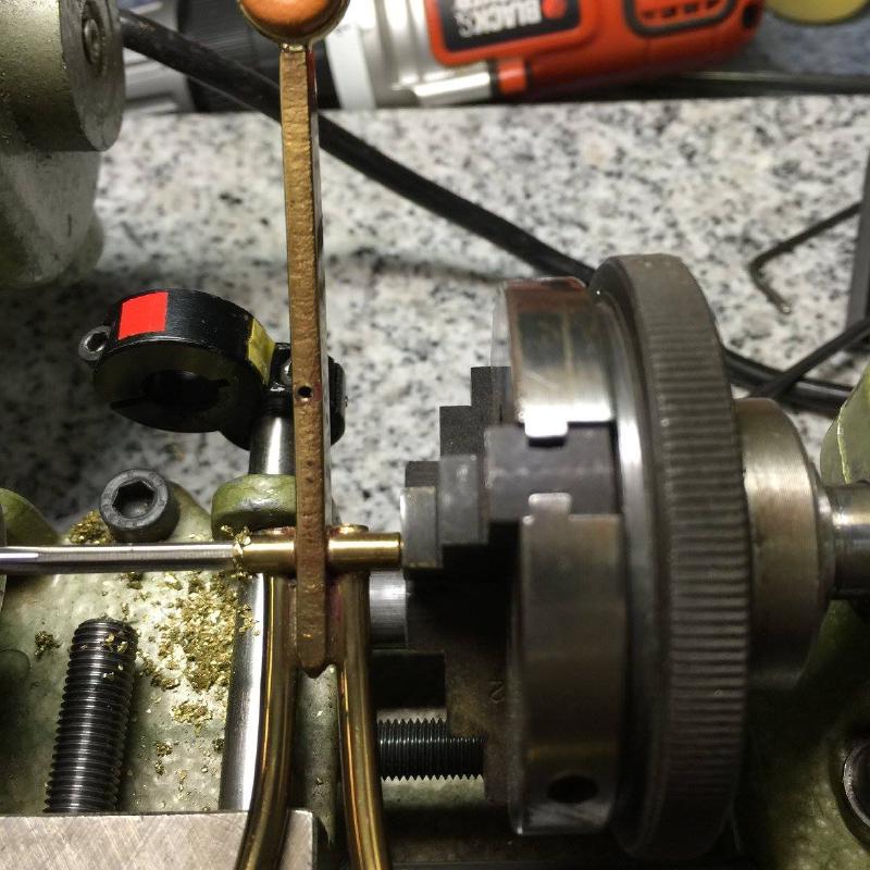 A short piece of hinge rod stock is also mounted in a chuck in the tail stock.