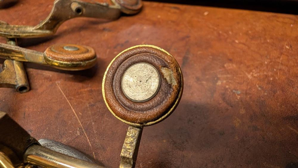 Close up of the large flat rivet used on palm keys in place of a reusable tone booster, off a Mark VI alto around serial 78,000 that had metal tone boosters everywhere else on the horn.